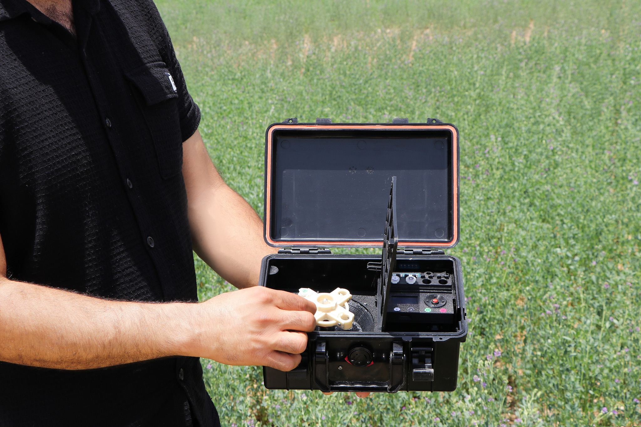 Using a sample vial with the ASAD device beside crops in the field